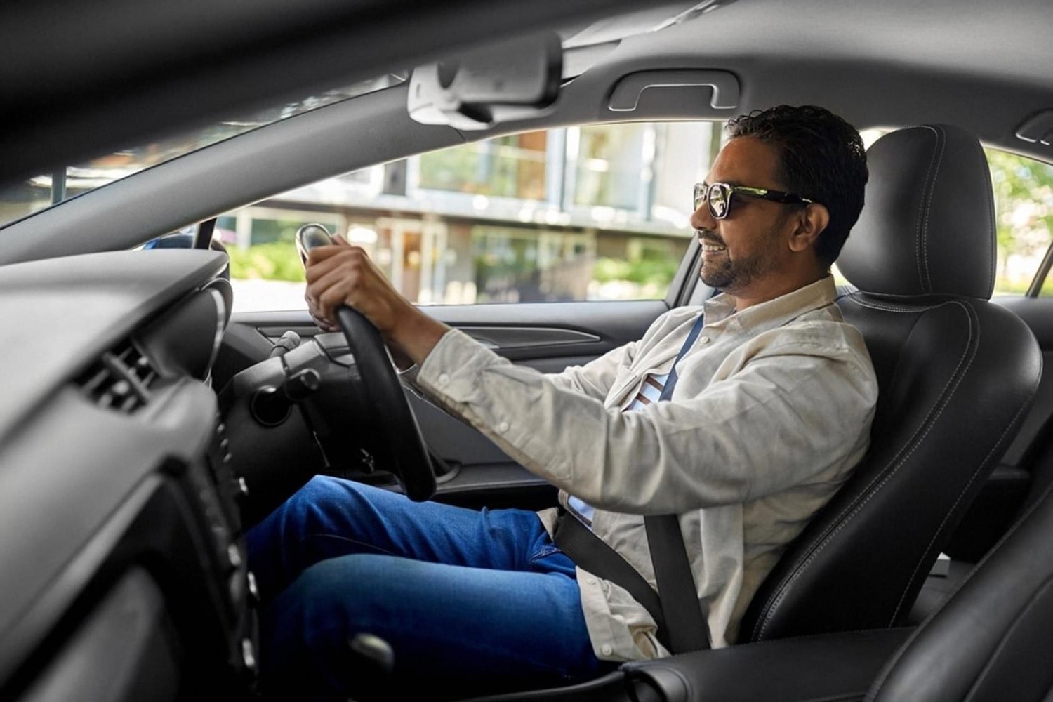 Driver behind the wheel of a car interior in a UAE city