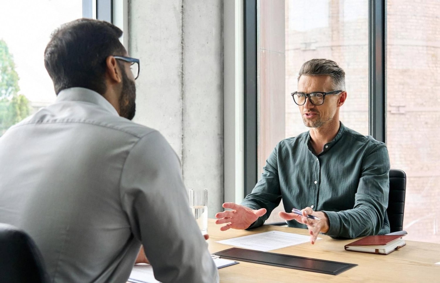 Compliance advisor discussing audit preparation documents with a UAE company director
